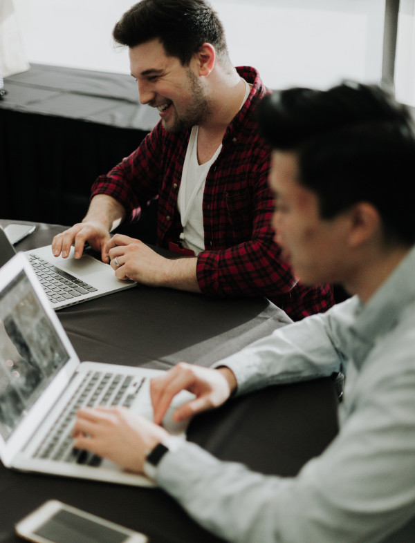 Two developers working on their laptops